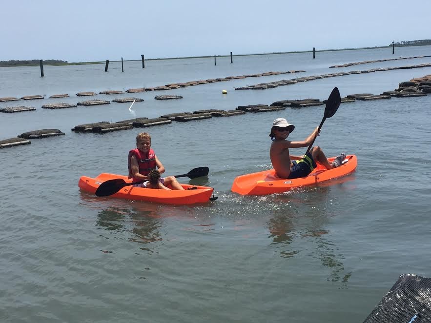 Charlie and Riley Morris kayak on the farm as children